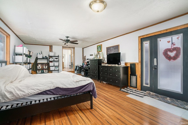 bedroom featuring crown molding, ceiling fan, and light wood-type flooring