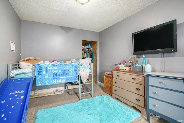 bedroom with carpet and a textured ceiling