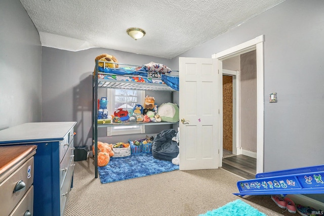 bedroom featuring a textured ceiling and carpet flooring