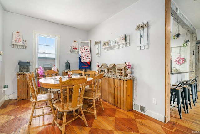 dining space with wood-type flooring and a water view