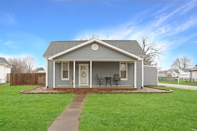 bungalow-style house with a front yard and covered porch