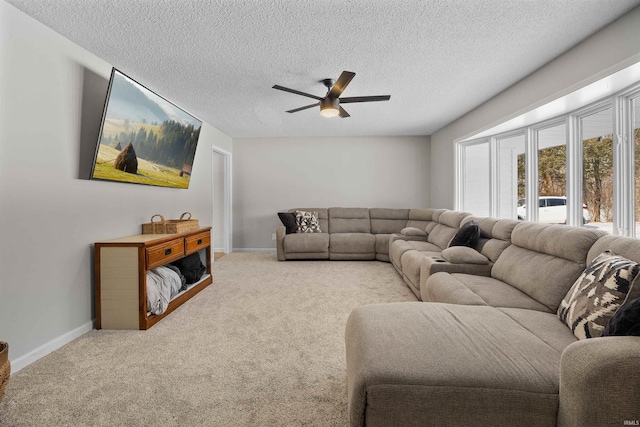 carpeted living room with a textured ceiling and ceiling fan