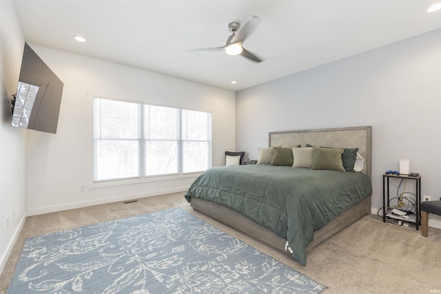 bedroom featuring light colored carpet and ceiling fan