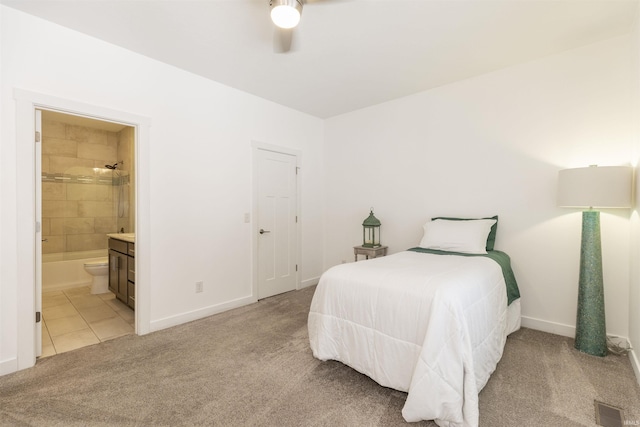 carpeted bedroom featuring ceiling fan and ensuite bathroom