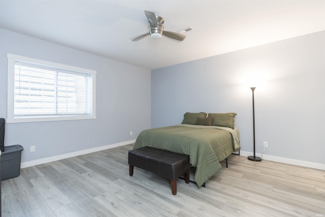 bedroom with light hardwood / wood-style floors and ceiling fan