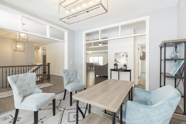 sitting room with hardwood / wood-style flooring and a chandelier