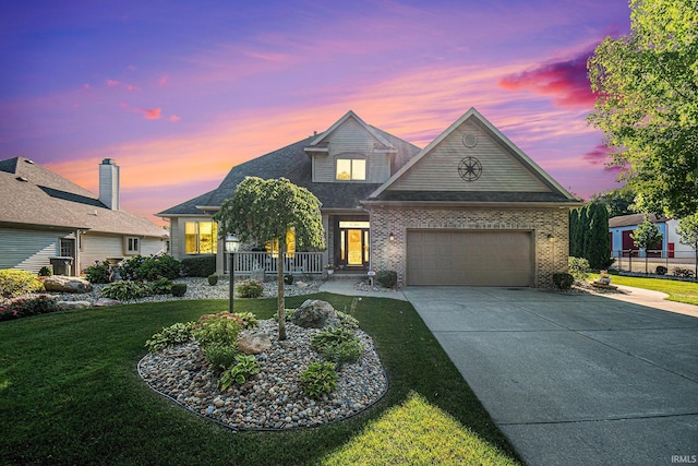 view of front of home featuring a yard and a garage