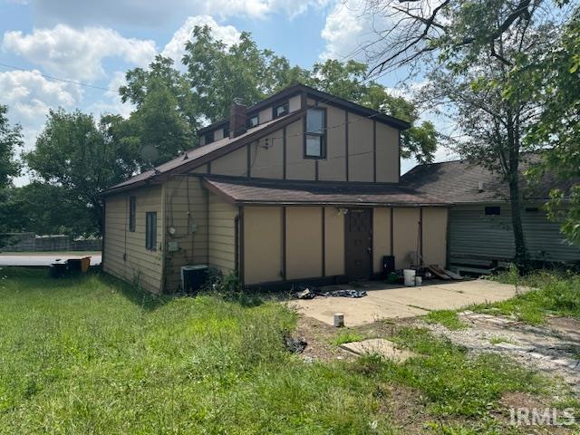 back of house with a lawn