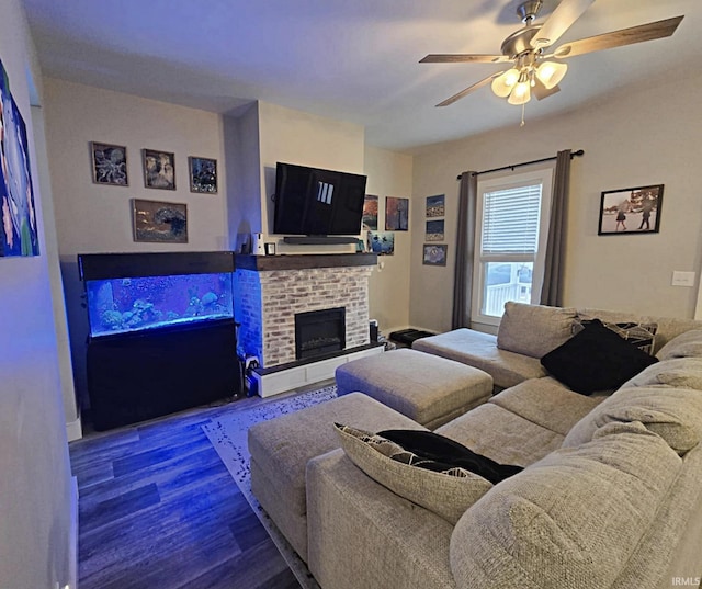 living room featuring a brick fireplace, hardwood / wood-style flooring, and ceiling fan