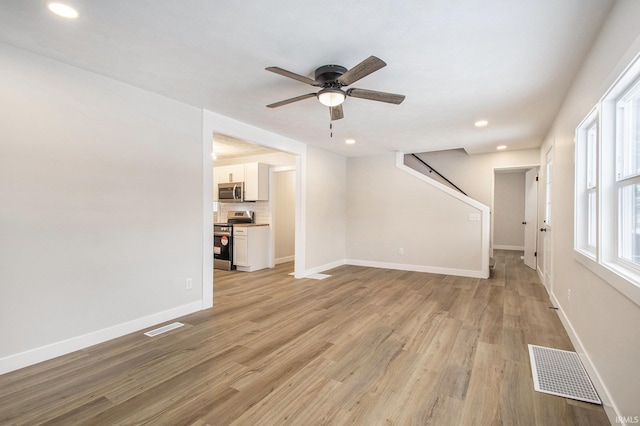 unfurnished living room with ceiling fan and light hardwood / wood-style flooring