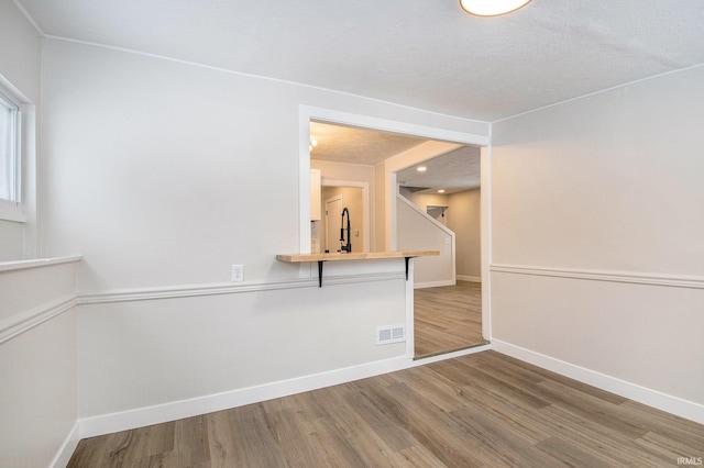 spare room with hardwood / wood-style flooring and sink