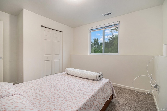 bedroom with carpet flooring and a closet