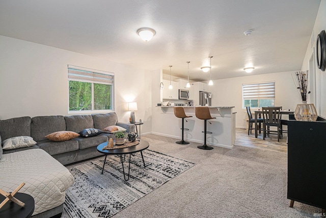 carpeted living room featuring a wealth of natural light