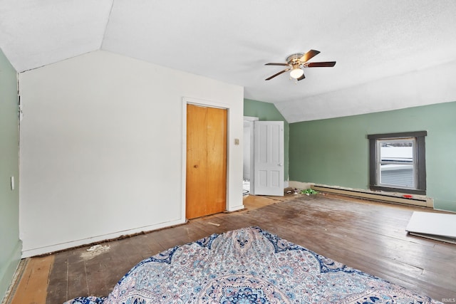 bedroom featuring vaulted ceiling, hardwood / wood-style floors, ceiling fan, and baseboard heating