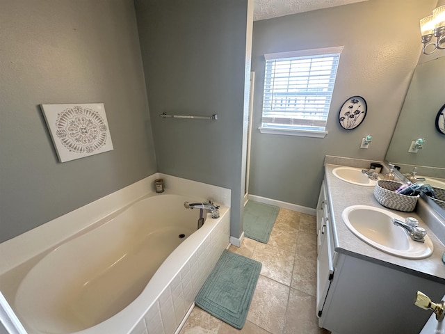 bathroom with vanity, tile patterned floors, and tiled bath