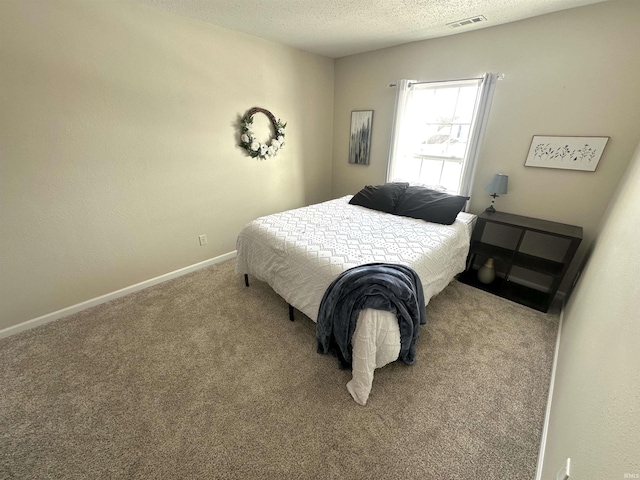 carpeted bedroom with a textured ceiling