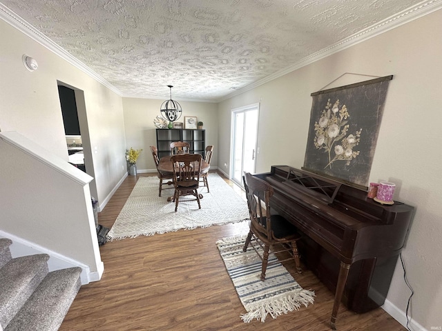 dining room with crown molding, dark wood-type flooring, and a textured ceiling