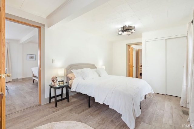 bedroom featuring light hardwood / wood-style floors and a closet