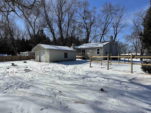 view of front of home with a garage and an outdoor structure