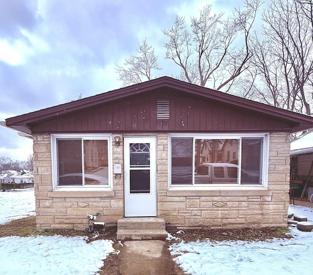 view of front of property with entry steps and stone siding