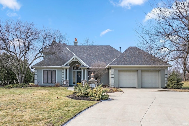 view of front of house with a garage and a front lawn