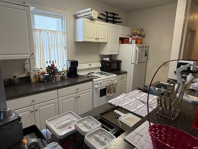 kitchen with white appliances and white cabinets