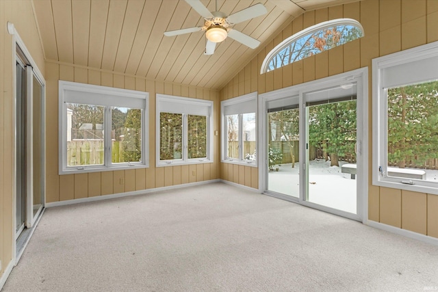 unfurnished sunroom featuring ceiling fan, wood ceiling, and lofted ceiling