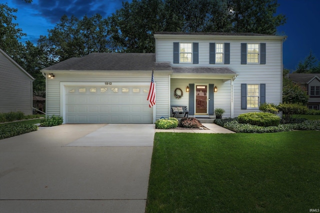 view of front facade featuring a yard, covered porch, and a garage