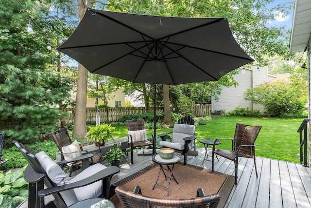 wooden deck featuring a lawn