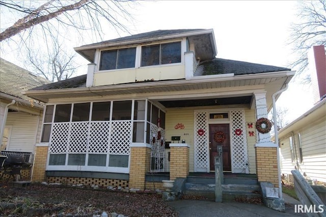 view of front of house featuring a sunroom