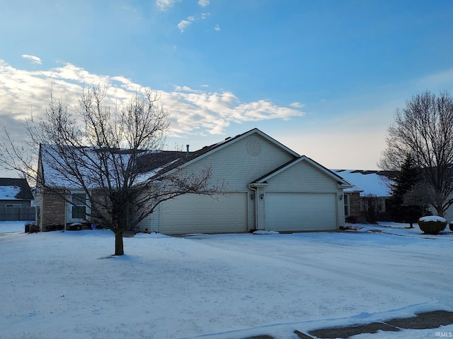 view of snow covered exterior with a garage