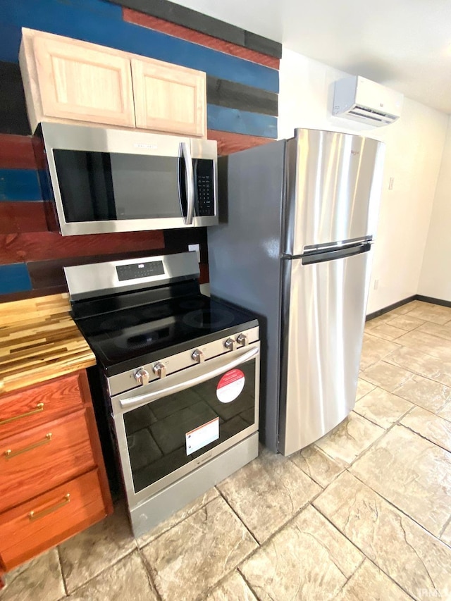 kitchen with an AC wall unit and stainless steel appliances