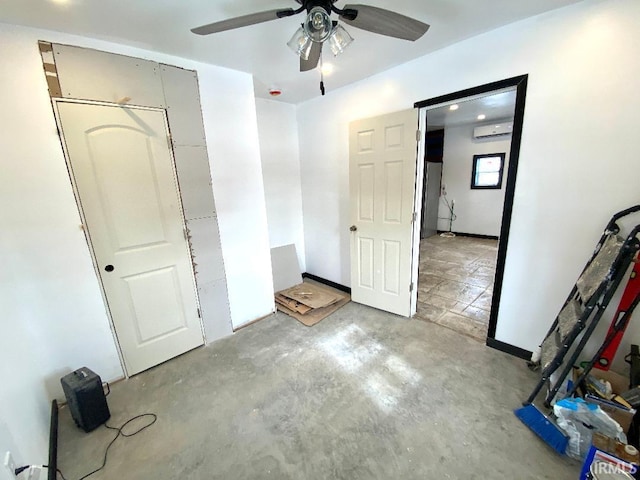 unfurnished bedroom featuring ceiling fan and a wall unit AC