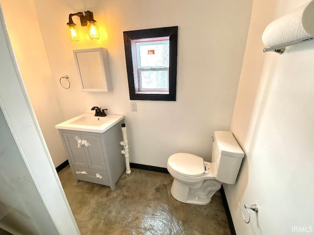 bathroom featuring toilet and vanity