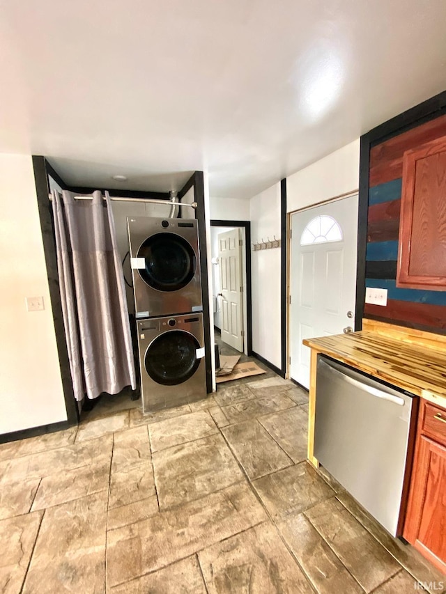 washroom featuring stacked washer / dryer