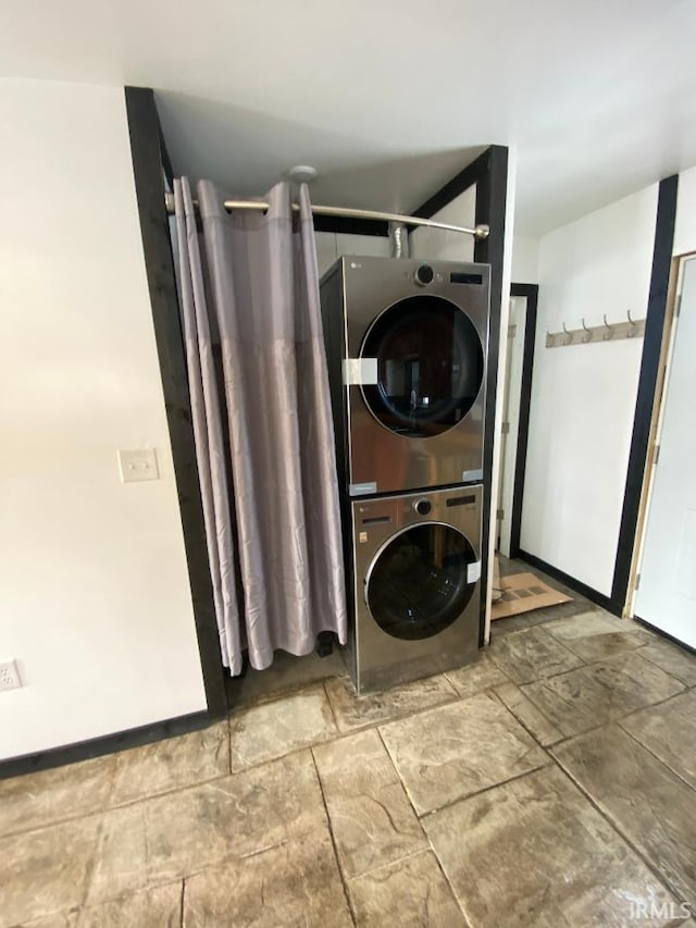 clothes washing area with stacked washer and dryer