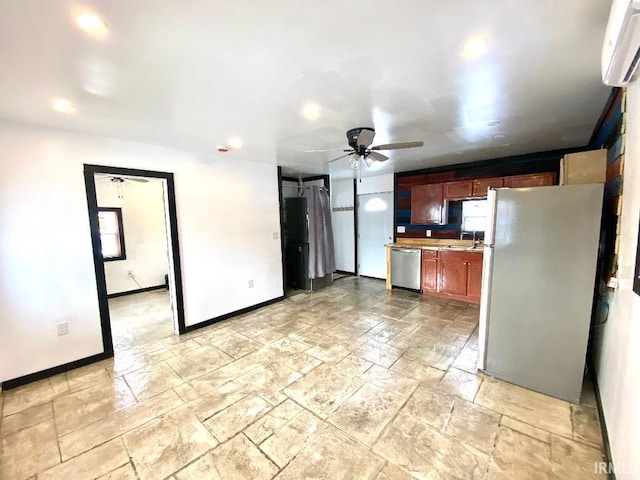 kitchen with ceiling fan, stainless steel appliances, a wall mounted AC, and sink