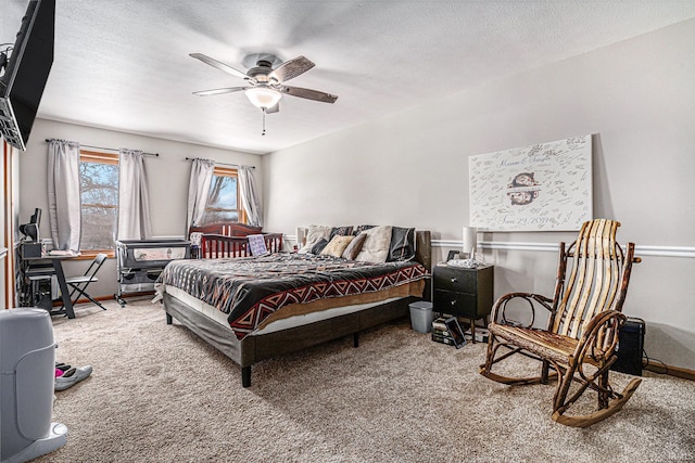 carpeted bedroom with ceiling fan and a textured ceiling
