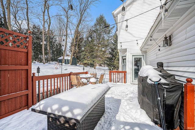 snow covered deck featuring grilling area