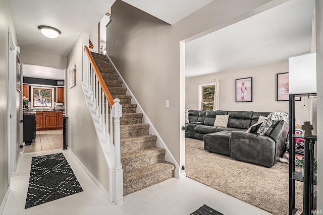 staircase with carpet and sink