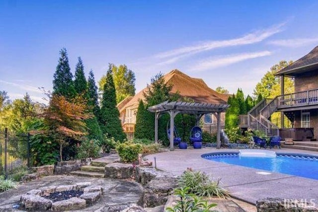 view of pool featuring a patio area, an outdoor fire pit, a pergola, and a hot tub