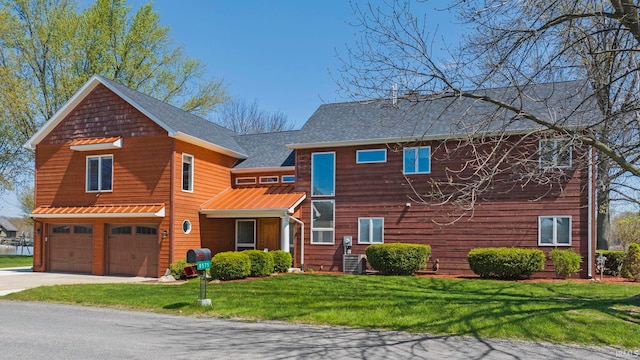 view of front of home with a garage and a front yard