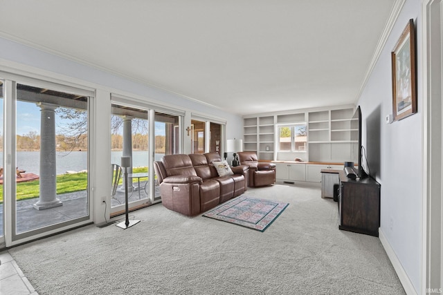 carpeted living room featuring ornamental molding, a water view, and built in shelves