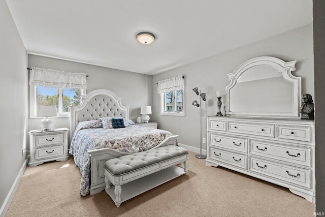 bedroom featuring multiple windows and light colored carpet