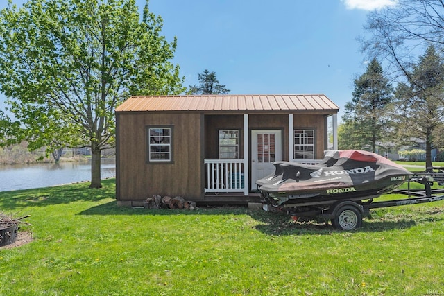 view of outdoor structure featuring a yard and a water view