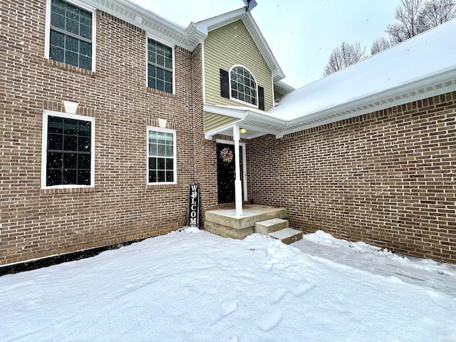 view of snow covered property entrance