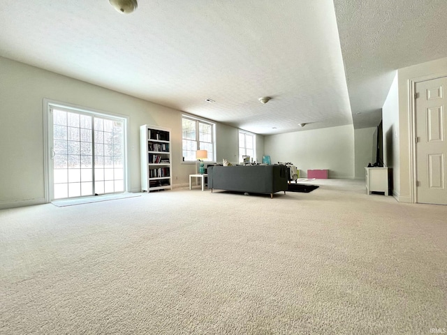 living room featuring light carpet and a textured ceiling