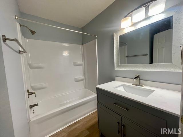 bathroom featuring vanity, shower / tub combination, and wood-type flooring