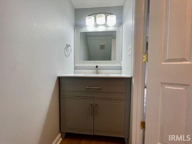 bathroom with hardwood / wood-style flooring and vanity