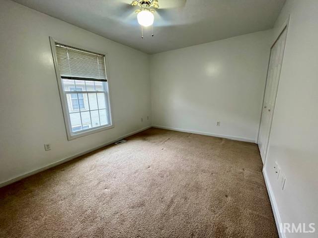 unfurnished bedroom with carpet floors and ceiling fan